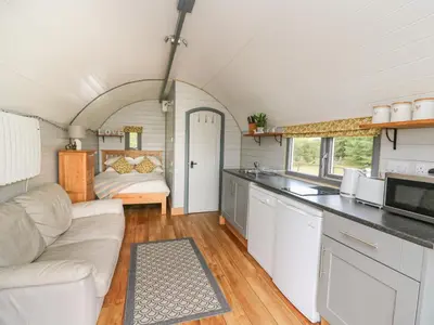 a kitchen and living room in a tiny house at Woodland View in Saint Harmon