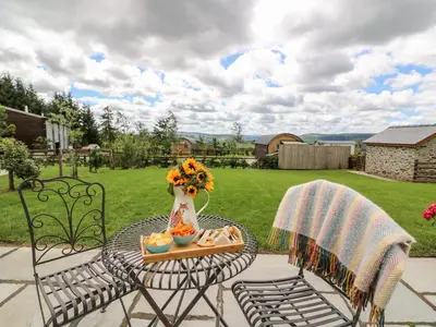 a table and chairs with a tray of food and flowers at Mountain View in Saint Harmon