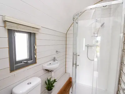 a bathroom with a shower and a toilet and a sink at Mountain View in Saint Harmon