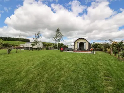 a large grassy field in front of a building at Mountain View in Saint Harmon