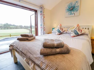 two beds with towels on them in a room with a window at Bothi in Bala