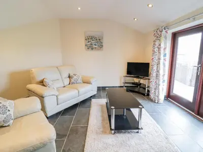 a living room with a couch and a tv at Bothi in Bala