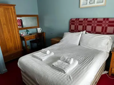 a bedroom with a bed with towels on it at Castle Hotel in Aberaeron