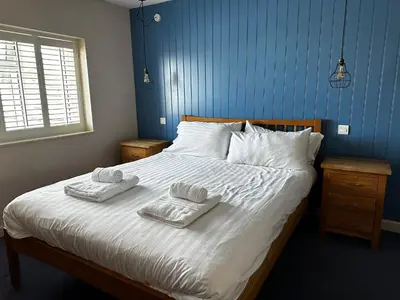 a bedroom with a bed with two towels on it at Castle Hotel in Aberaeron