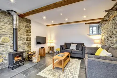 a living room with a couch and a fireplace at 2 Bed in Machynlleth oc-bow39 in Darowen