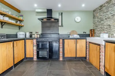 a large kitchen with a black oven and a counter at 3 Bed in Machynlleth oc-bow40 in Darowen