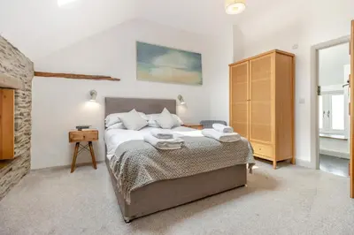 a bedroom with a bed and a wooden cabinet at 3 Bed in Machynlleth oc-bow40 in Darowen
