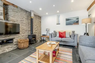 a living room with a couch and a fireplace at 3 Bed in Machynlleth oc-bow40 in Darowen