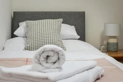 a bed with a white blanket and a pillow at 5 Bed in Machynlleth oc-bow30 in Darowen