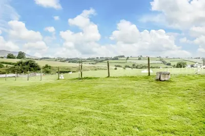 a field with a tree stump in the middle of it at 3 Bed in Bala oc-bow26 in Llanuwchllyn