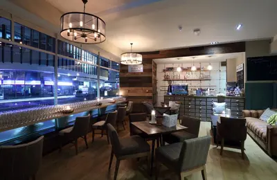 a restaurant with tables and chairs and a bar at The Loopy Shrew in Shrewsbury
