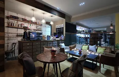 a restaurant with a bar with a table and chairs at The Loopy Shrew in Shrewsbury