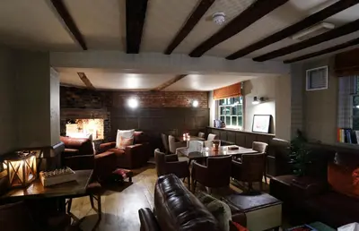 a restaurant with couches and tables in a room at The Loopy Shrew in Shrewsbury