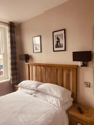 a bedroom with a bed and two pictures on the wall at The Loopy Shrew in Shrewsbury
