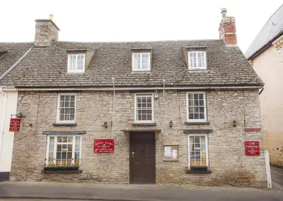an old stone building with a brown door at Seven Stars in Hay-on-Wye