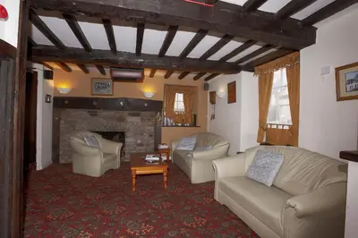 a living room with two couches and a fireplace at Seven Stars in Hay-on-Wye