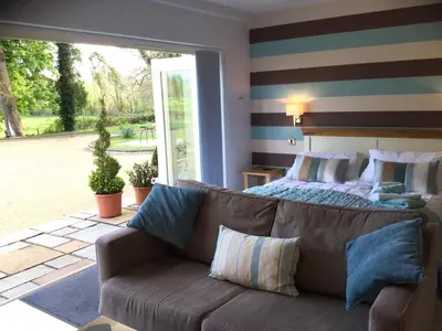 a living room with a couch and a bed at Plas Y Dderwen Apartments in Aberystwyth
