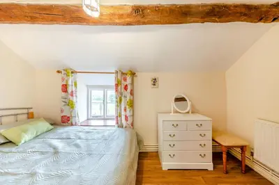 a bedroom with a bed and a dresser and a window at 3 Bed in Bala oc-waf247 in Bettws Gwerfil Goch