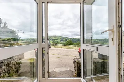 an open glass door with a view of a road at 3 Bed in Bala oc-waf247 in Bettws Gwerfil Goch
