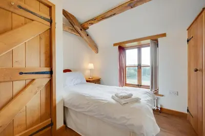 a bedroom with a white bed and a window at 3 Bed in Dolgellau oc-wah570 in Llanfachreth