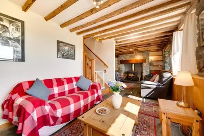 a living room with a red couch and a table at 3 Bed in Dolgellau oc-wah570 in Llanfachreth