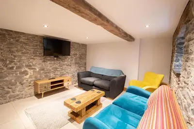 a living room with a blue couch and a table at 3 Bed in Llangadfan oc-wae284 in Llangadfan