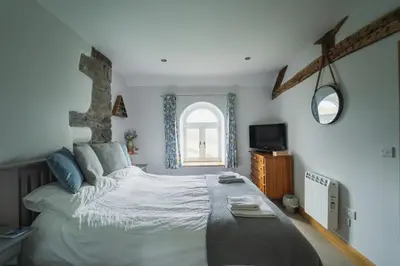 a bedroom with a large bed and a window at 3 Bed in Llangadfan oc-wae284 in Llangadfan
