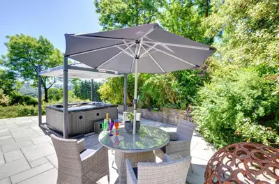 a table with an umbrella on a patio at Bryncylla in Llangurig