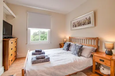 a bedroom with a large bed and a television at 4 Bed in Barmouth oc-wah585 in Penmaenpool