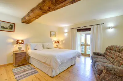 a bedroom with a bed and a couch at 4 Bed in Dolgellau oc-wah568 in Llanfachreth