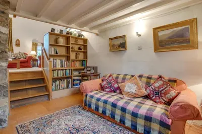 a living room with a couch and a book shelf at 3 Bed in Dolgellau oc-wah484 in Llanfachreth