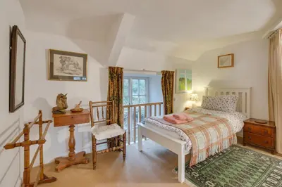 a bedroom with a bed and a desk and a chair at 3 Bed in Dolgellau oc-wah484 in Llanfachreth
