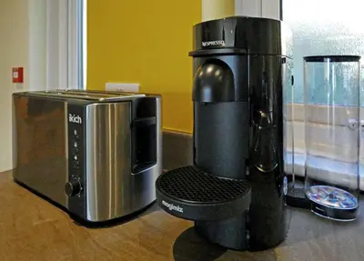 a coffee maker and a microwave on a counter at Bryn Melyn Apartments in Barmouth