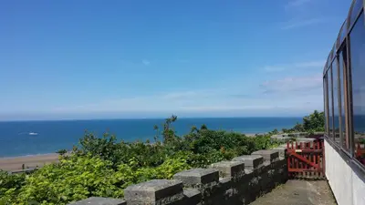a view of the ocean from a train at Tyr Graig Castle in Barmouth
