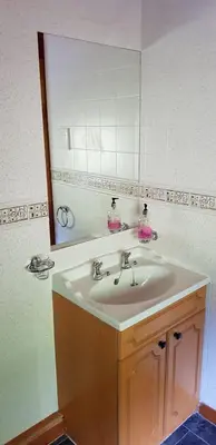a bathroom with a sink and a mirror at Hilltop Cottage/ Penrhiw in Maentwrog