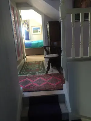 a stairway leading to a bedroom with a bed at Tallow House in Ludlow