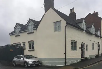 a car parked in front of a white house at Tallow House in Ludlow