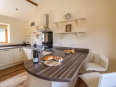 a kitchen with a wooden counter top in a room at Pentre Fach in Llanddewi Ystradenny