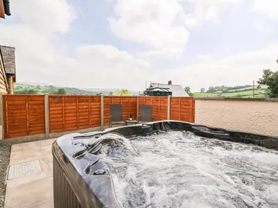 a hot tub on the roof of a house at Pentre Fach in Llanddewi Ystradenny