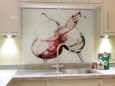 a kitchen sink with a wine glass painting on the wall at Woodpecker Cottage in Ludlow