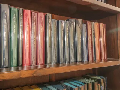 a row of books sitting on a book shelf at The Courtyard in Kington