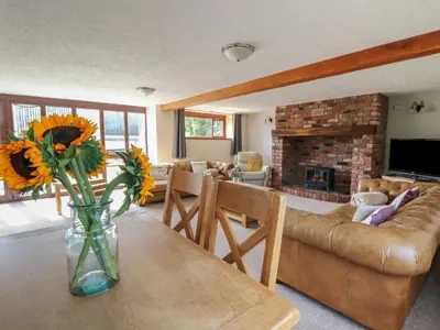 a living room with a vase of flowers on a table at Glanyrafon in Rhayader