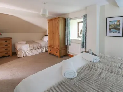a bedroom with a large bed and aermottermottermottermott at Glanyrafon in Rhayader
