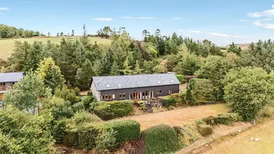 an aerial view of a house in a field at Glanyrafon Bungalow in Rhayader