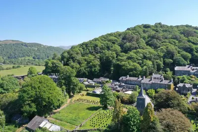 an aerial view of a village in the hills at Grapes Hotel, Bar & Restaurant Snowdonia Nr Zip World in Blaenau-Ffestiniog