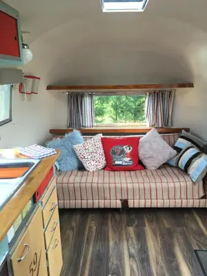 a living room with a couch in a caravan at Ludlow Vintage Airstream in Ludlow