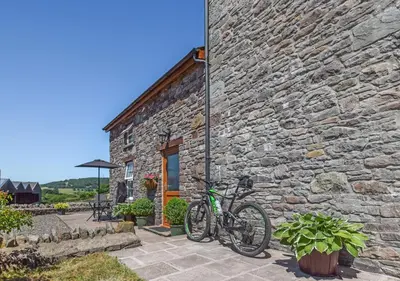 a bicycle parked outside of a stone building at 1 Bed in Nantygwreiddyn oc-bow49 in Sennybridge