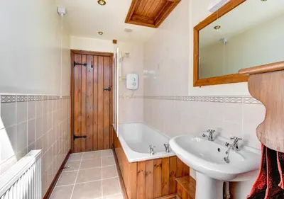 a bathroom with a sink and a bath tub at 1 Bed in Nantygwreiddyn oc-bow49 in Sennybridge