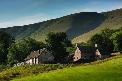 an old house on a hill in a green field at The House In The Hills in Velindre