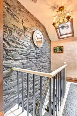 a stone wall with a clock on a staircase at 3 Bed in Machynlleth oc-bow43 in Corris